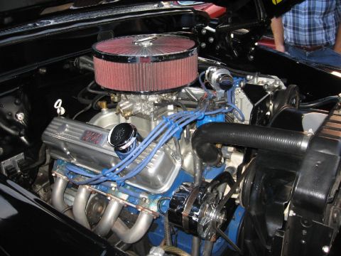 1966 Ford F-100 - Close-up of a V8 engine, chrome accents and aftermarket headers.