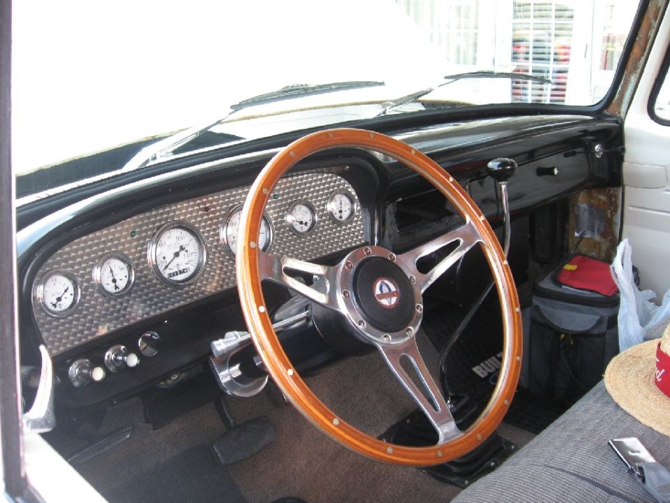 1966 Ford F-100 interior with wooden steering wheel and custom gauges