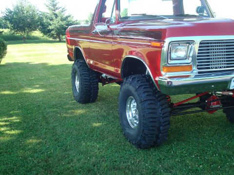 1978 Ford Bronco - This lifted 1978 Ford Bronco features oversized tires and a prominent grille, its off-road capabilities.