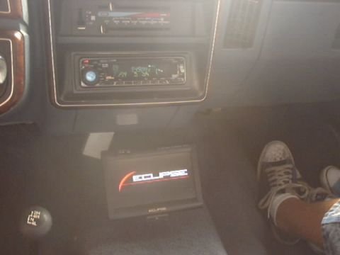 1990 Ford Bronco - Interior view of a vehicle's dashboard aftermarket audio equipment and a gear shifter.