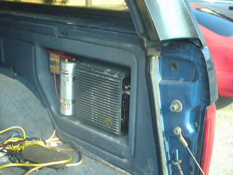 1990 Ford Bronco - Aftermarket car stereo components are visible inside a blue vehicle.