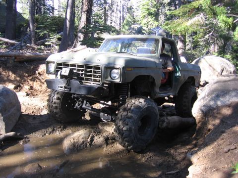 1989 Ford Bronco - This modified 1979 Ford Bronco navigates a challenging off-road course with large tires and a lifted suspension.