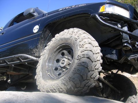 1989 Ford Bronco - This modified truck is equipped for off-road adventures with its aggressive tires and protective exterior features.