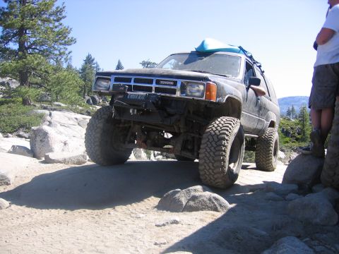 1989 Ford Bronco - This modified Toyota 4Runner navigates a challenging off-road path with a kayak secured to its roof.