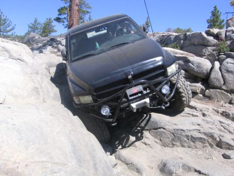 1989 Ford Bronco - This modified truck navigates a challenging rocky trail, its off-road capabilities.