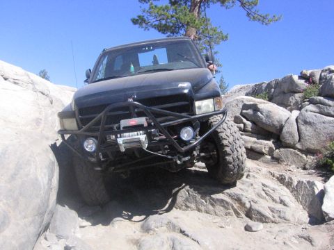 1989 Ford Bronco - Truck is on a rocky trail, likely off-roading.