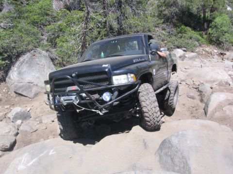 1989 Ford Bronco - This modified truck navigates a challenging rocky trail, its off-road capabilities.