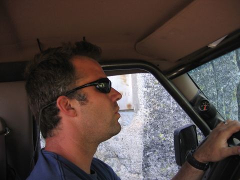 1989 Ford Bronco - Driver's perspective inside an off-road vehicle, with a gauge mounted on the A-pillar.