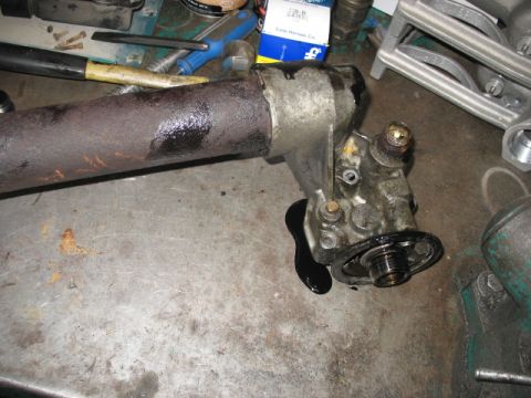 1995 Ford C-350 (Centurion Conversions) - Close-up of an oil cooler assembly with a pipe, showing signs of leakage on a workbench.