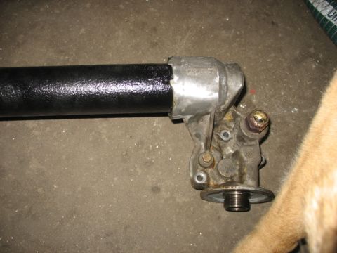 1995 Ford C-350 (Centurion Conversions) - Close-up of an oil cooler assembly with a black pipe, likely a vehicle part.