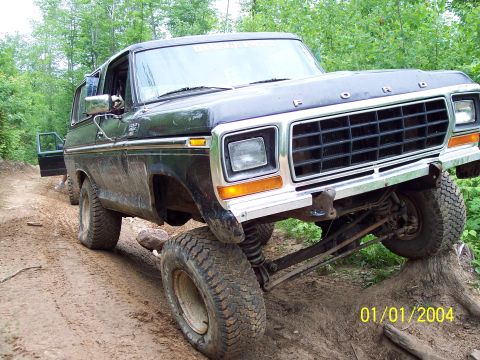 1979 Ford Bronco - This lifted 1978 Ford Bronco is navigating an off-road trail with one wheel off the ground.