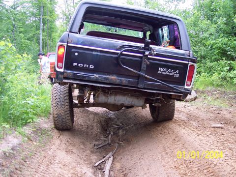1979 Ford Bronco - The Bronco navigates a rough dirt path with a second vehicle following closely behind.