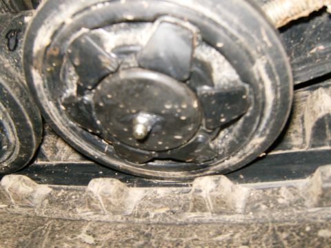 2000 Ford E350 - Detail of a track roller and tread, showing wear and dirt accumulation.