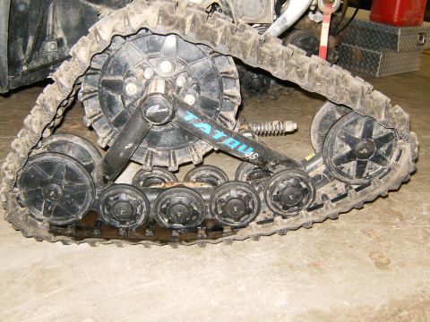 2000 Ford E350 - A snowmobile track system with visible TATOU4S branding and some fluid leakage.