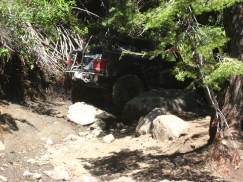 1989 Ford Bronco - 1989 Ford Bronco tackling a difficult rocky trail during an off-road excursion.