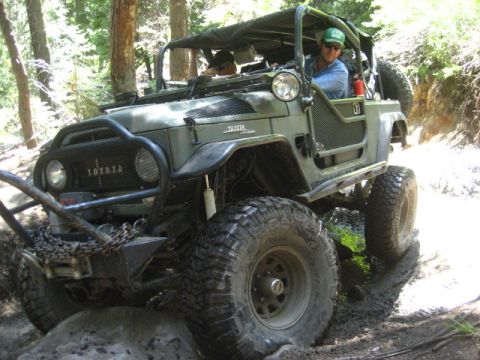 1989 Ford Bronco - This modified Toyota Land Cruiser FJ40 navigates a challenging off-road path.