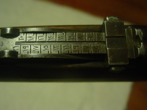 1979 Ford Bronco - The rear sight of a firearm displays Arabic numerals and other markings.