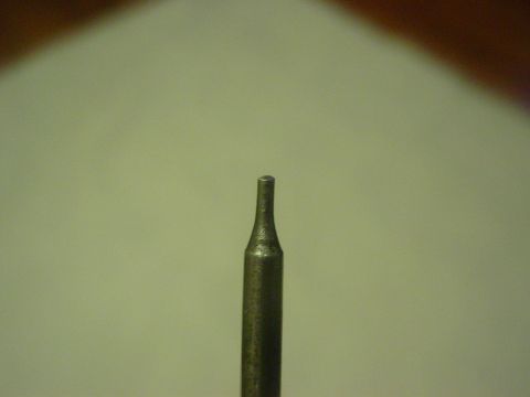 1979 Ford Bronco - A close-up shot focuses on a metal tool bit, possibly for a drill or engraving, with a distinct pointed end.