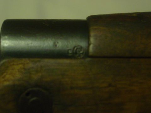 1979 Ford Bronco - Close-up view of a firearm's receiver and wooden stock, showing some markings.