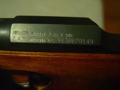1979 Ford Bronco - Close-up of the receiver markings on a Mosin-Nagant rifle, indicating it is a Russian M91/30 chambered in 7.62x54R.