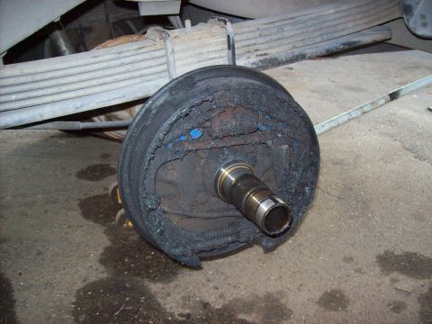 1995 Ford Bronco - This vehicle's brake drum shows significant damage to the brake shoes and drum lining.
