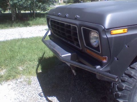 1978 Ford Bronco - The front grille and headlights of a 1978 Ford Bronco are visible, along with a custom bumper.