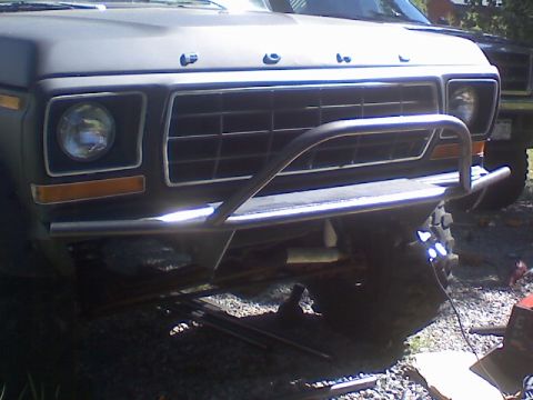 1978 Ford Bronco - The front grille and headlights of a Ford truck, possibly a 1979 model, are shown with a custom bumper and auxiliary lights.