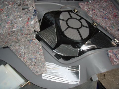 1996 Ford Bronco - Speaker installation in a car interior, showing removed panel and sound deadening.