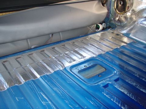 1996 Ford Bronco - Installing sound deadening material on the vehicle's floor and rear cargo area.
