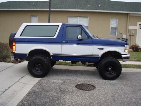 1996 Ford Bronco - This lifted Ford Bronco features a two-tone paint scheme and large off-road tires.