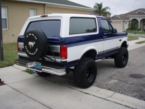 1996 Ford Bronco - This lifted Ford Bronco features a two-tone paint scheme and a rear-mounted spare tire.