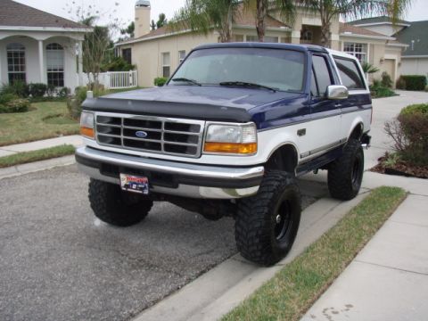 1996 Ford Bronco - This lifted 1996 Ford Bronco features a two-tone blue and white paint scheme and aggressive off-road tires.