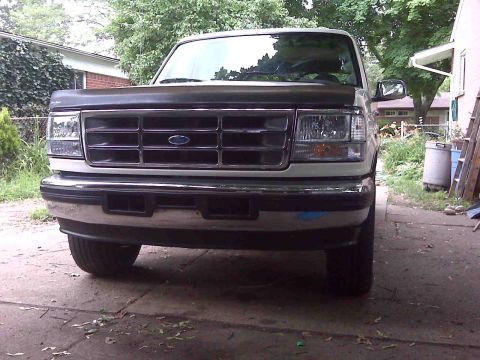 1995 Ford Bronco - The front grille and headlights of a 1995 Ford Bronco are visible in this photo.