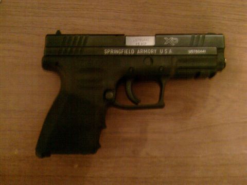 1985 Ford F-150 - Springfield Armory XD pistol shown on a wooden surface.
