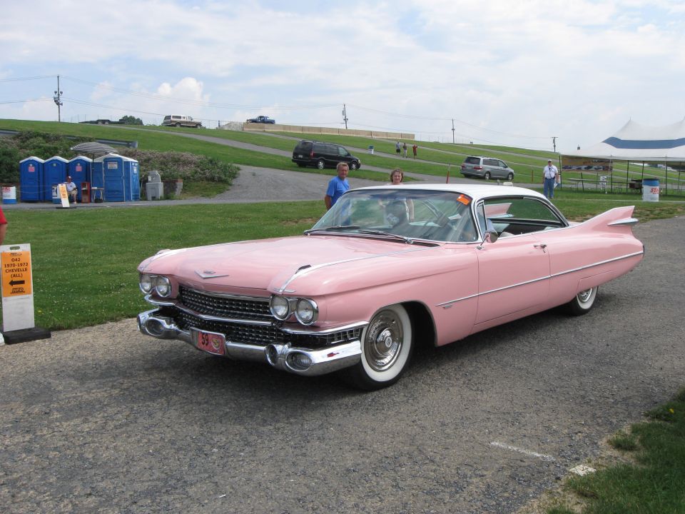 Pink 1959 Cadillac Coupe de Ville with white roof and tail fins