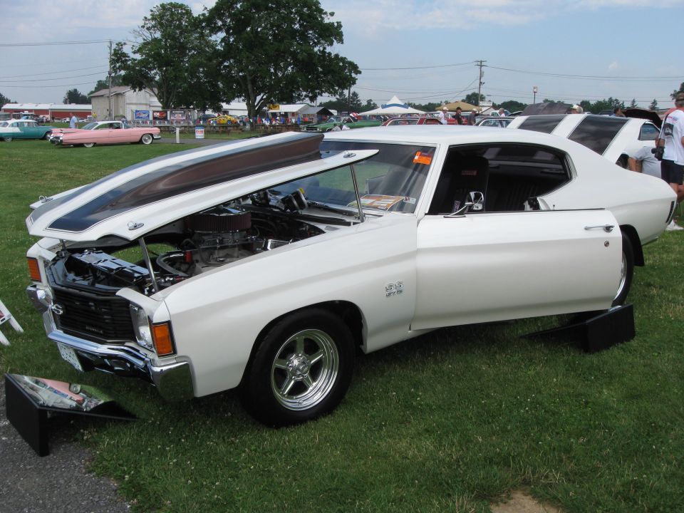 White 1970 Chevrolet Chevelle SS with hood and door open, showing engine