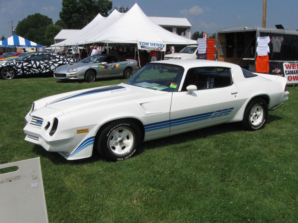 White 1978 Chevrolet Camaro Z28 with blue stripes parked on grass