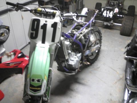 2004 Honda TRX 400 EX - A dirt bike, partially disassembled, displays the number 911 on its front plate.