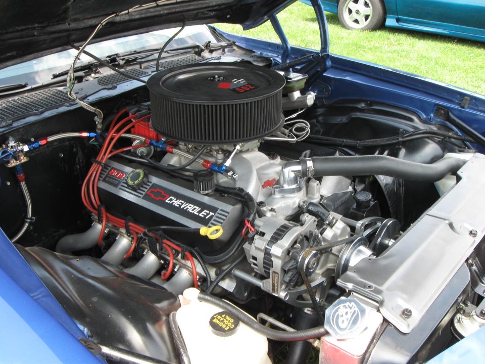 Blue Chevrolet engine with black air filter and chrome components