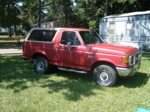 1989 Ford Bronco - This 1989 Ford Bronco is parked on the lawn next to a mobile home.