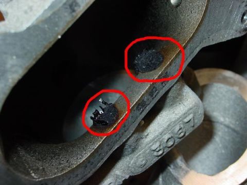 2007 Ford Mustang - Damage is visible on this engine component, which has the number 3067 stamped on it.