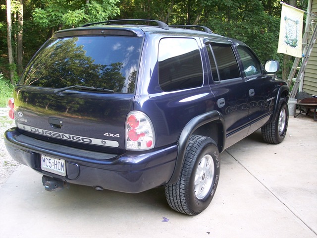 2007 Dodge Durango rear view, dark blue paint, "DURANGO 4X4" badge visible on tailgate