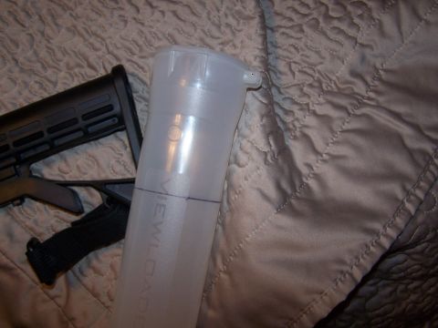 1986 Ford Bronco - A rifle stock and a plastic tube are visible on a quilted surface.