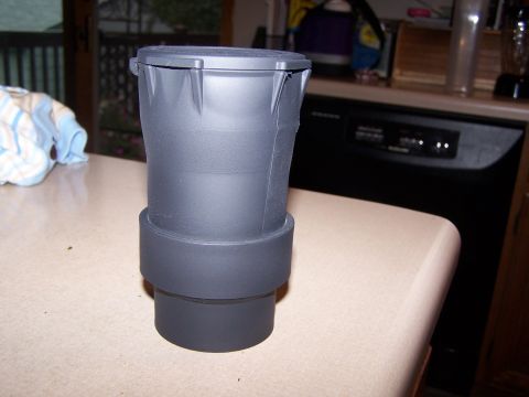 1986 Ford Bronco - A black plastic part, possibly a cap or container, rests on a kitchen countertop next to a dishwasher.