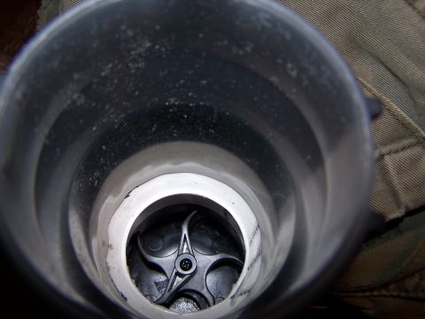 1986 Ford Bronco - View inside a vehicle's intake manifold, showing a black plastic flap mechanism.