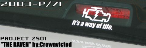 2003 Ford Crown Victoria - The rear window of a vehicle displays a K&N sticker and project details, with the text '2003-P/71' visible.