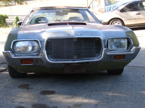 1973 Ford Ranchero - Front view of a 1973 Ford Ranchero, parked outdoors with another vehicle in the background.