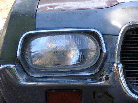 1973 Ford Ranchero - This vehicle's front end shows signs of wear and tear, with rust visible on the chrome bumper and surrounding body panels.