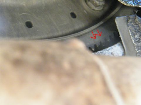 1982 Ford Bronco - A close-up view of a toothed metal component, possibly part of an engine or transmission.