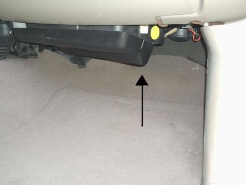 2007 Ford Mustang - The cabin air filter housing is visible in the interior of the vehicle, with an arrow indicating a specific area.